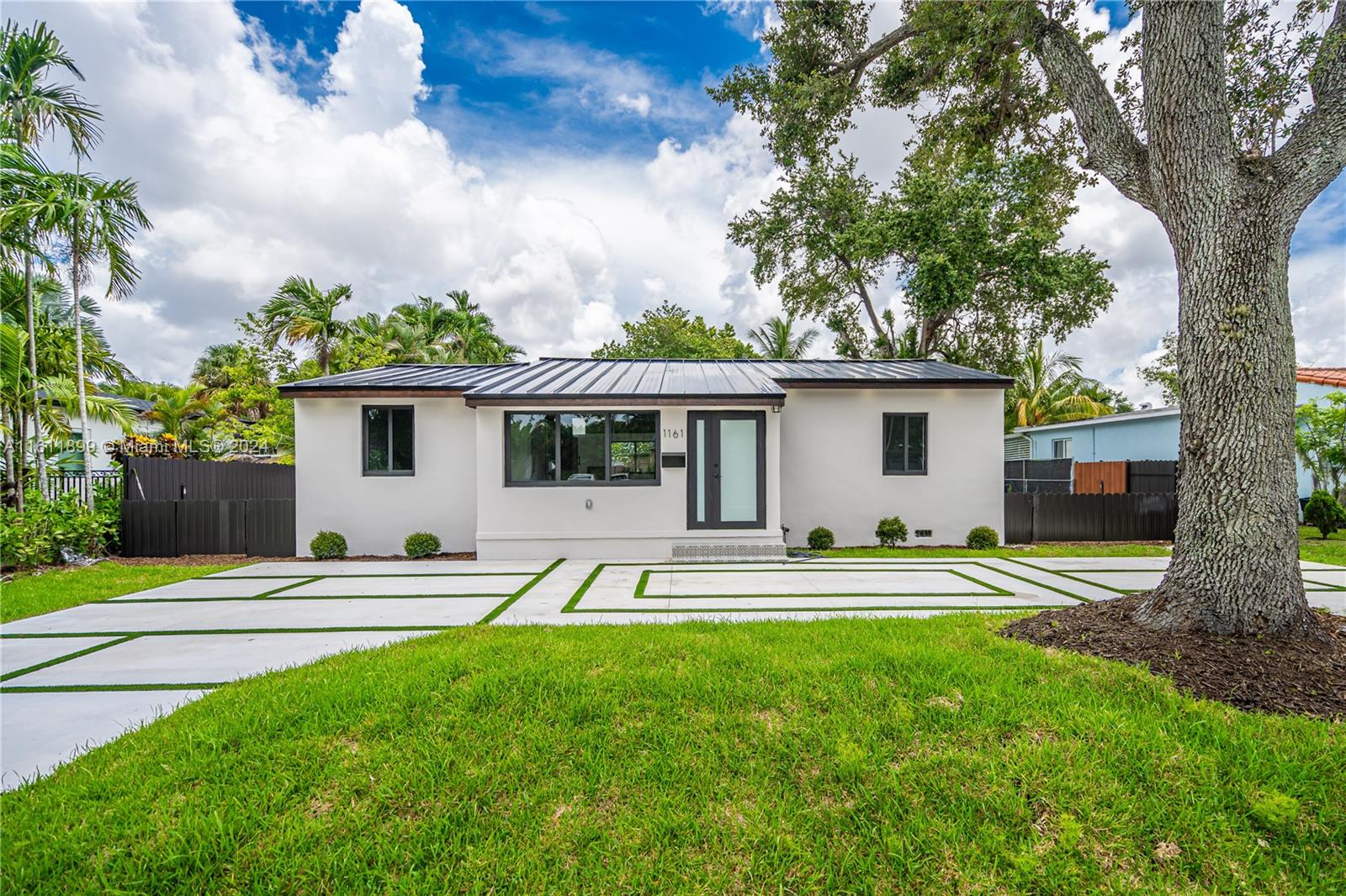 a house view with a sitting space and garden