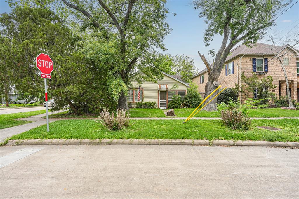 a front view of a house with a yard and tree s