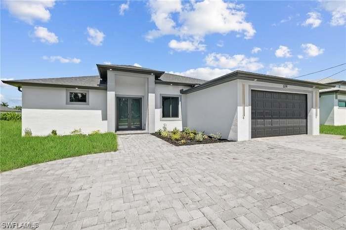 a front view of a house with a yard and garage