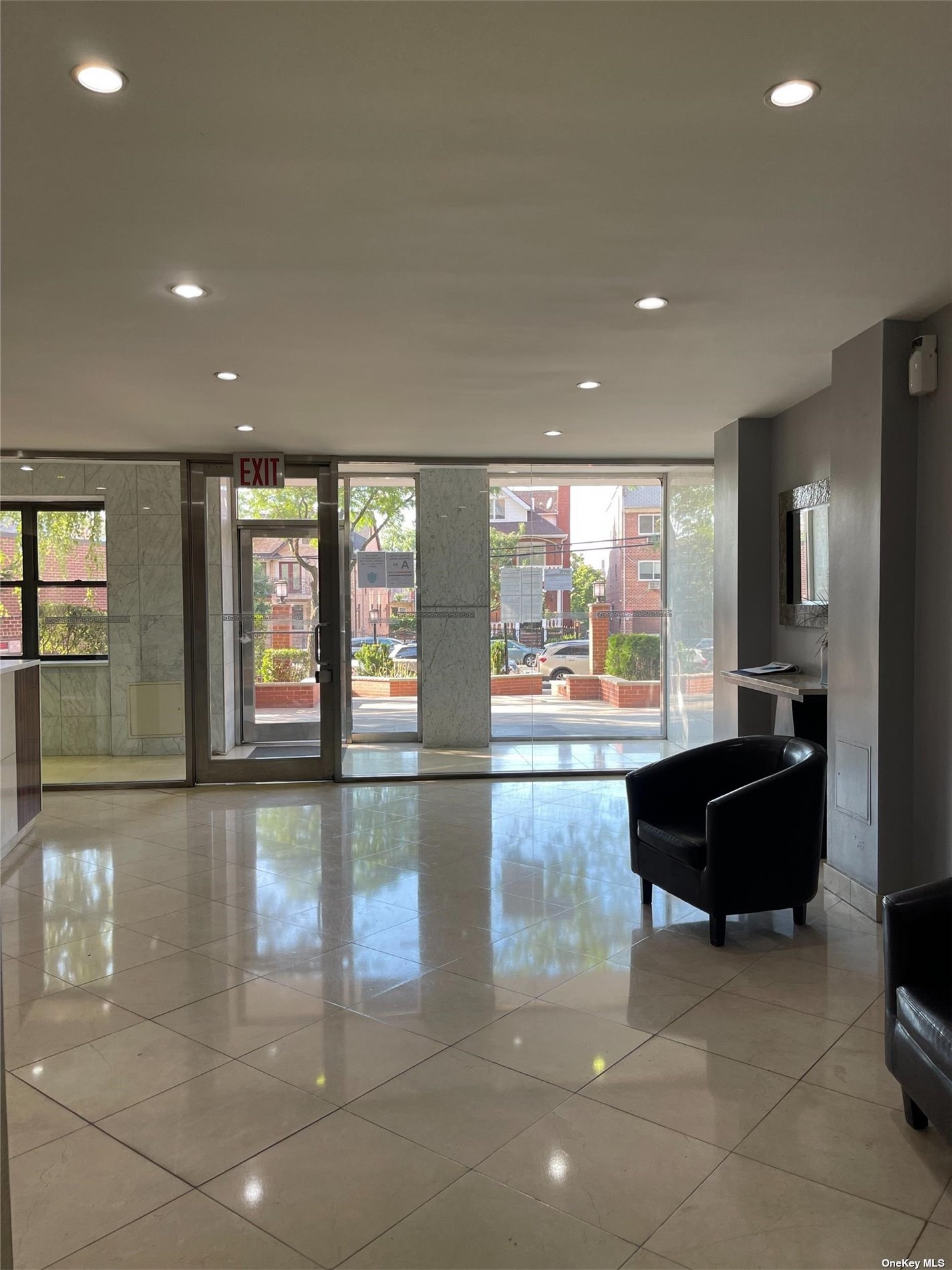 a living room with stainless steel appliances dining table chairs and a large window