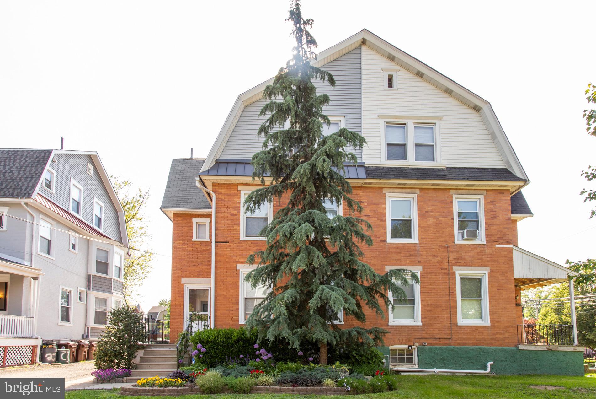 a front view of a residential apartment building with a yard