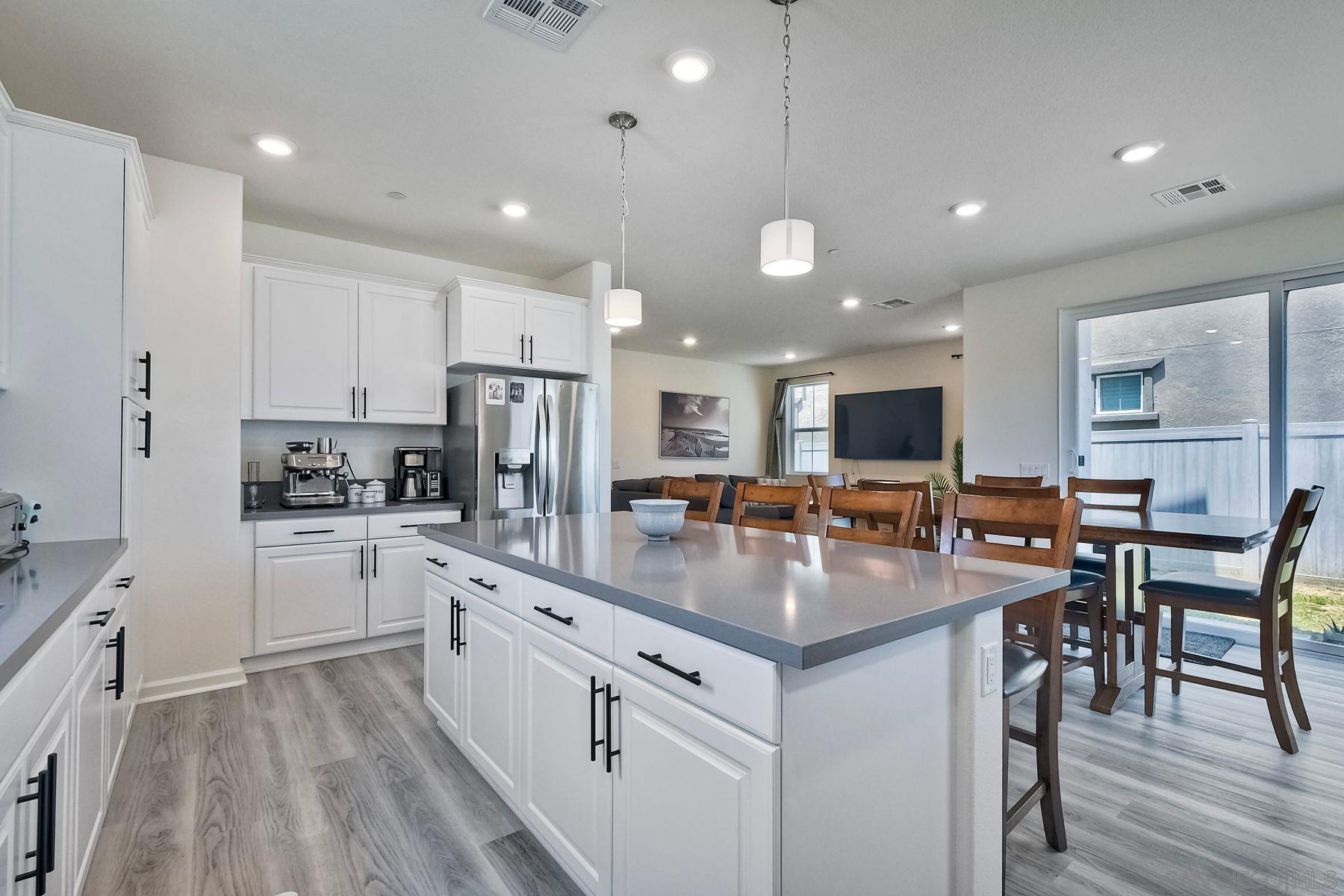 a kitchen with white cabinets stove and center island