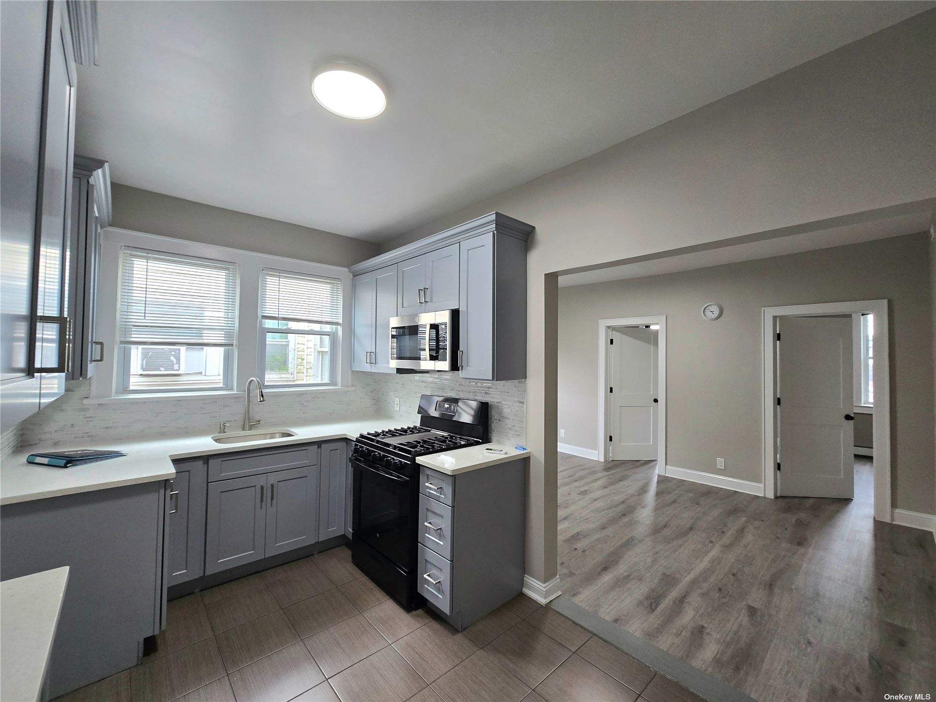 a kitchen with a sink stove and cabinets