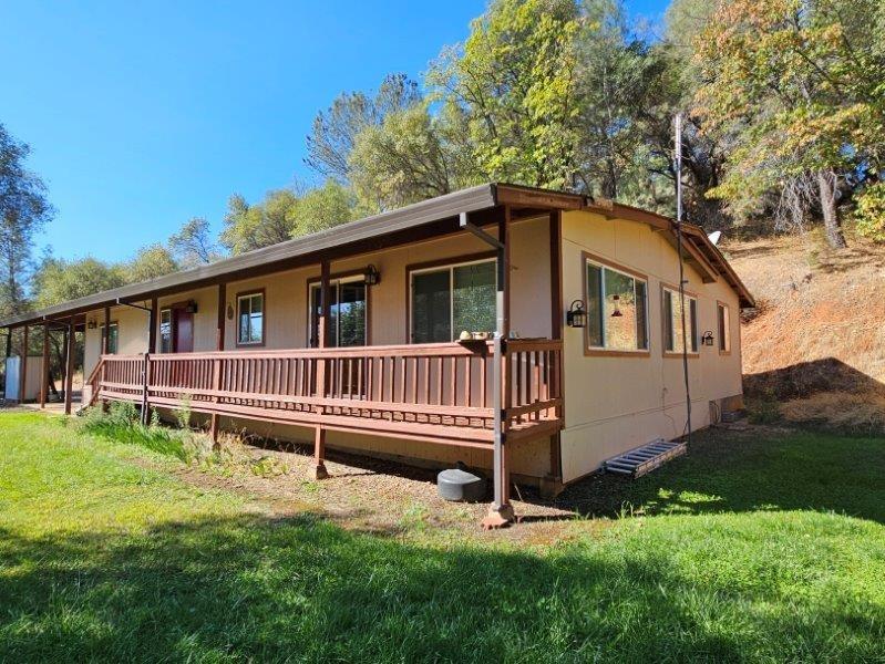 a view of a house with a yard and deck