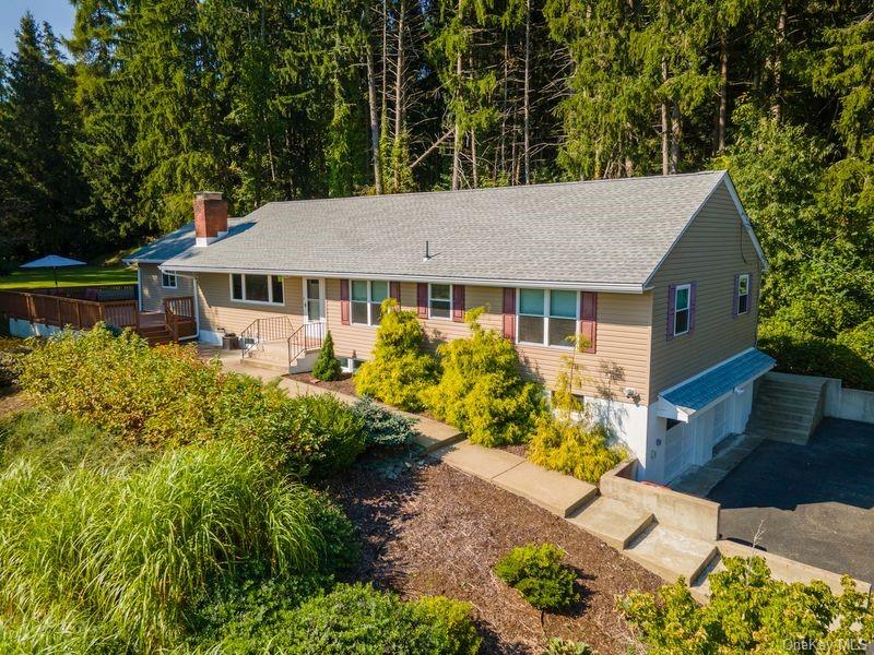 Single story home with a wooden deck and a garage