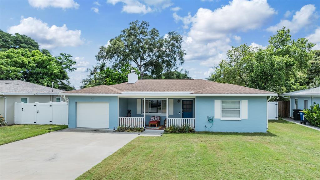 a view of a house with a yard and tree s