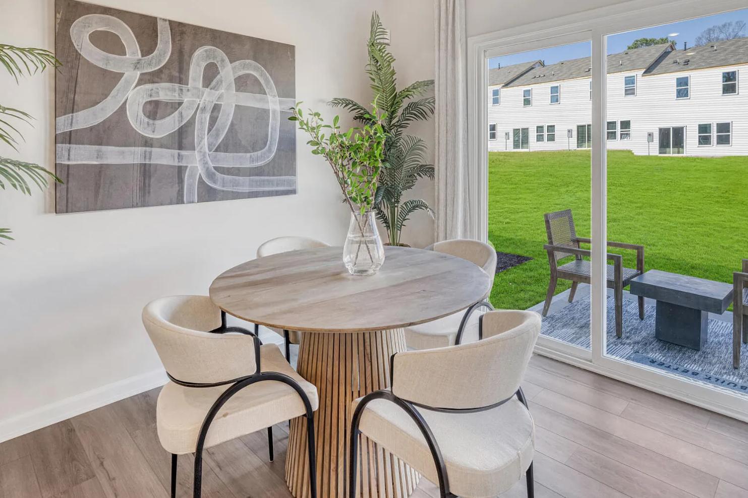 a table with chairs and a potted plant