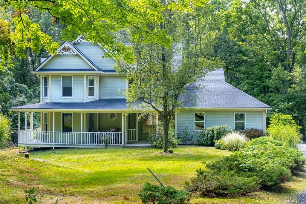 View of front of house featuring a front yard and covered porch