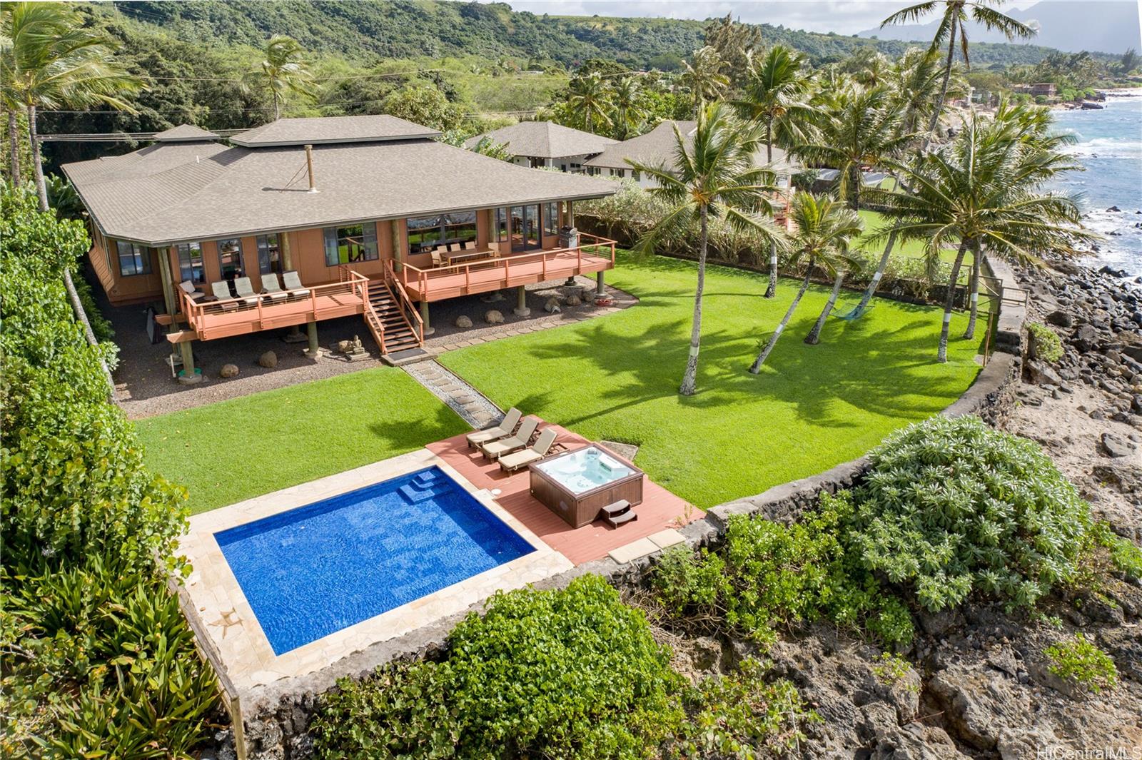 an aerial view of a house with swimming pool garden and patio