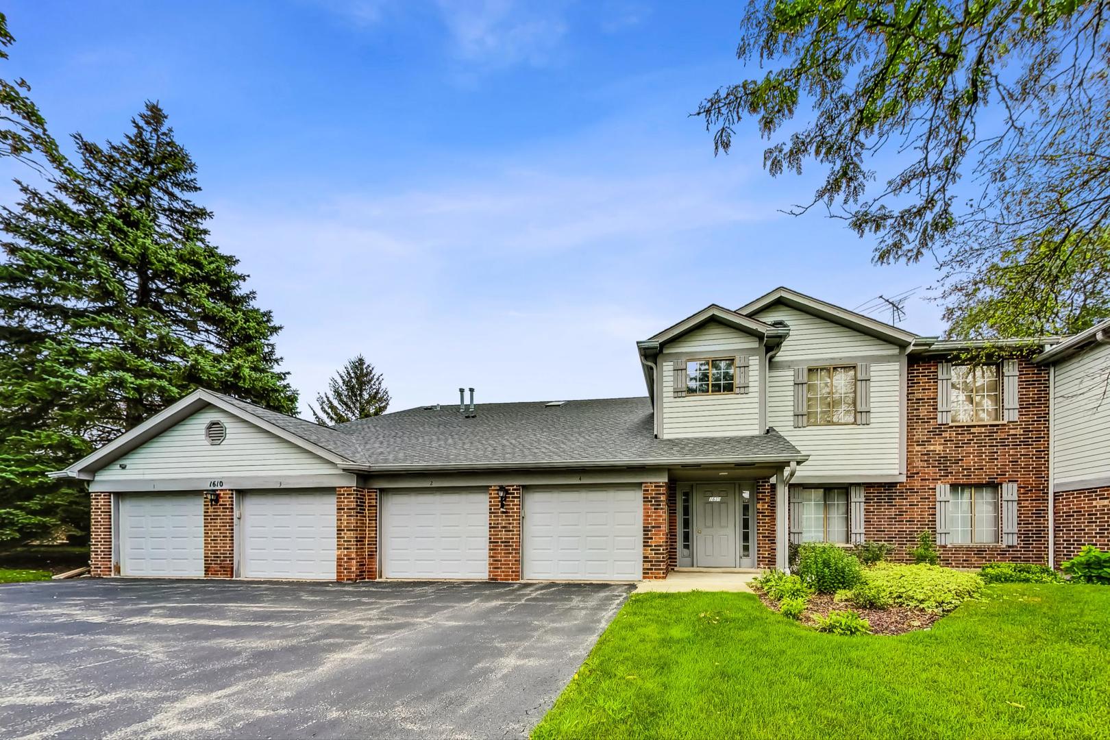 a view of a house with a big yard and large trees