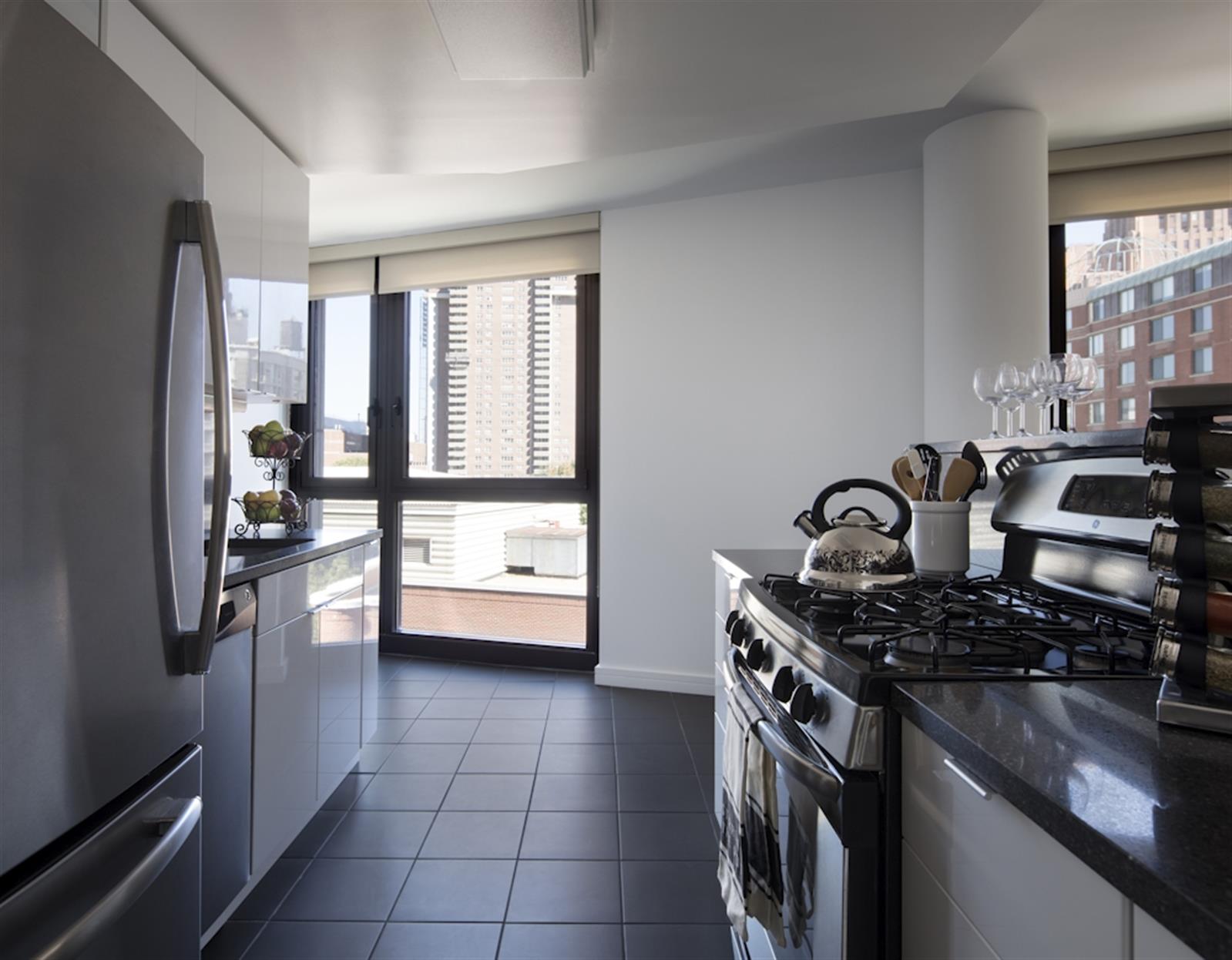 a kitchen with a stove a sink and a refrigerator