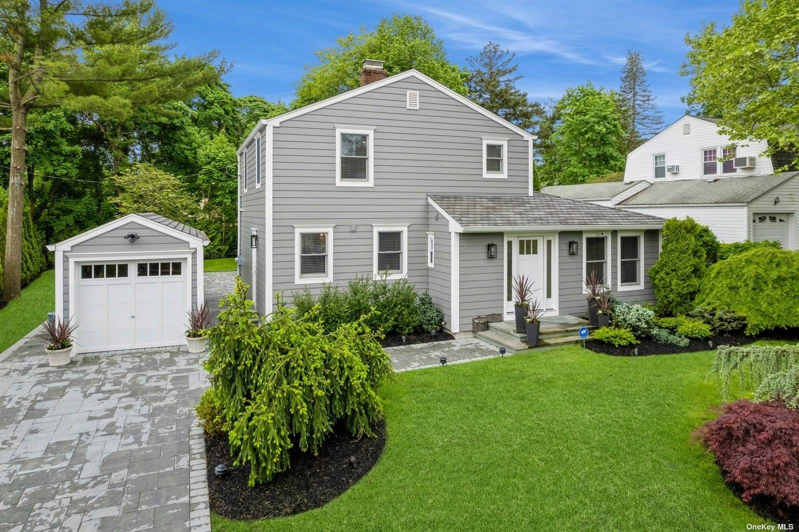 a front view of a house with a yard and porch