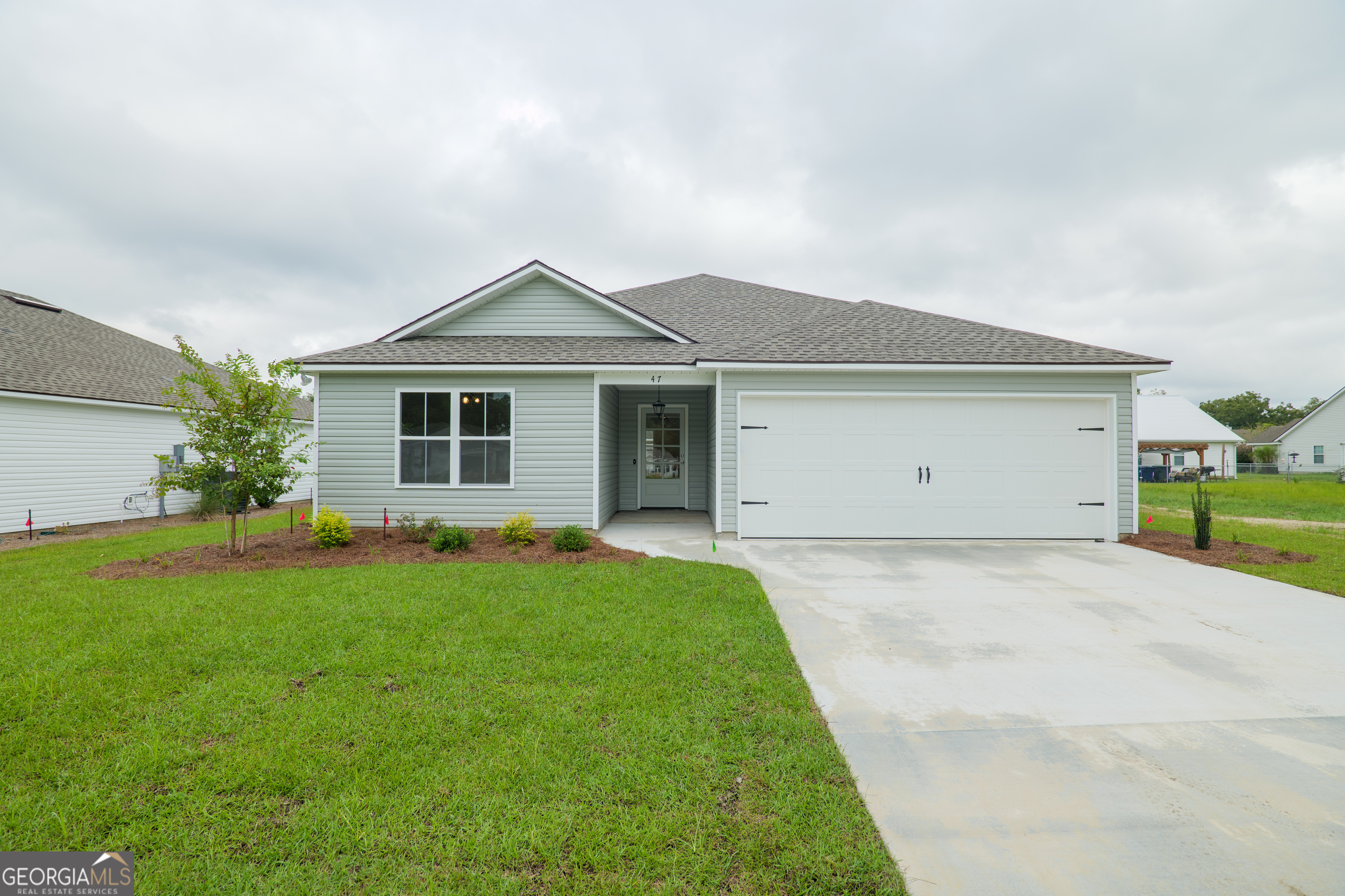 a front view of house with yard and green space