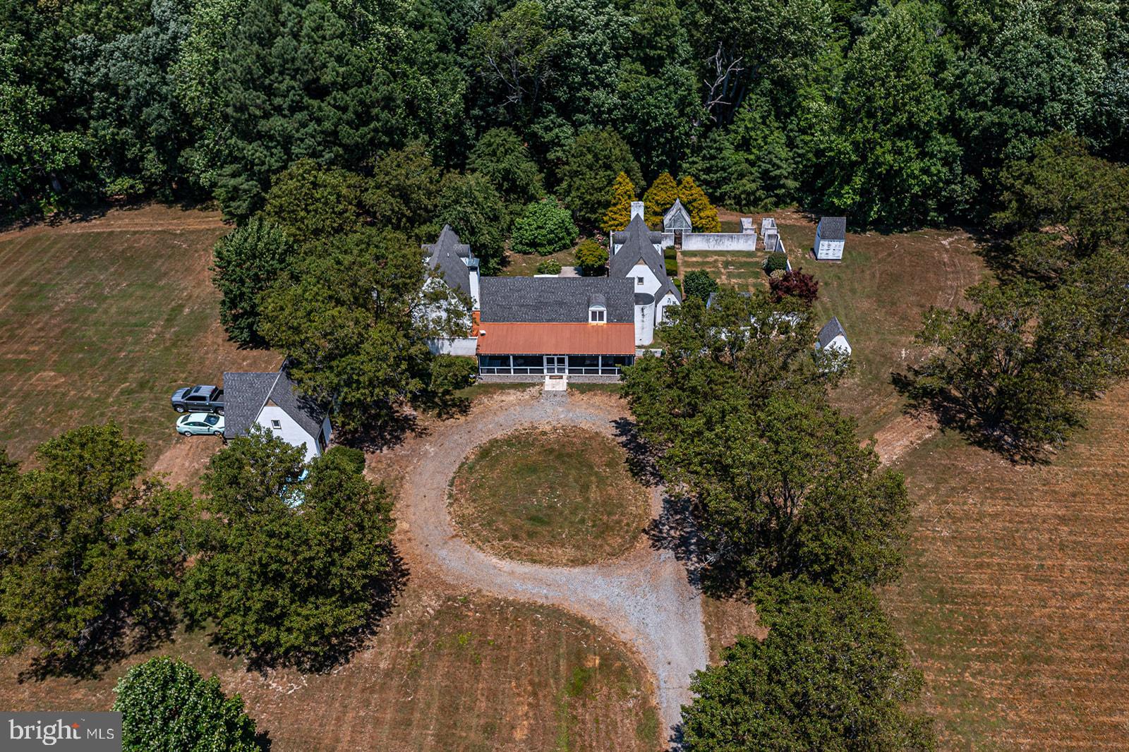 an aerial view of a house with a yard and lake view