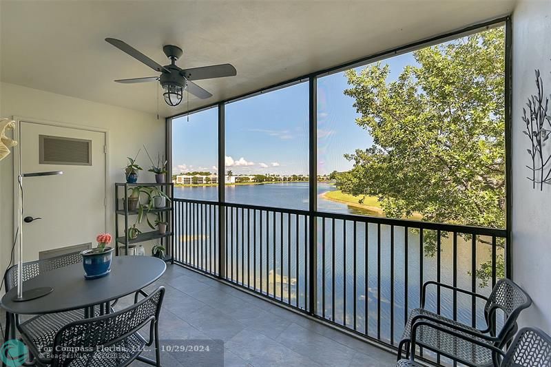 a view of a balcony furniture and a floor to ceiling window