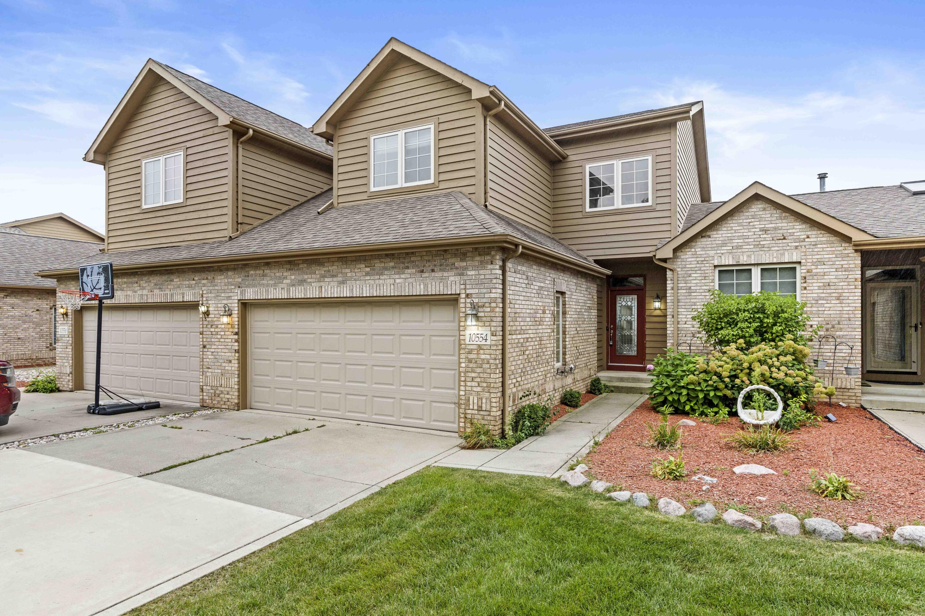 a front view of a house with a yard and garage