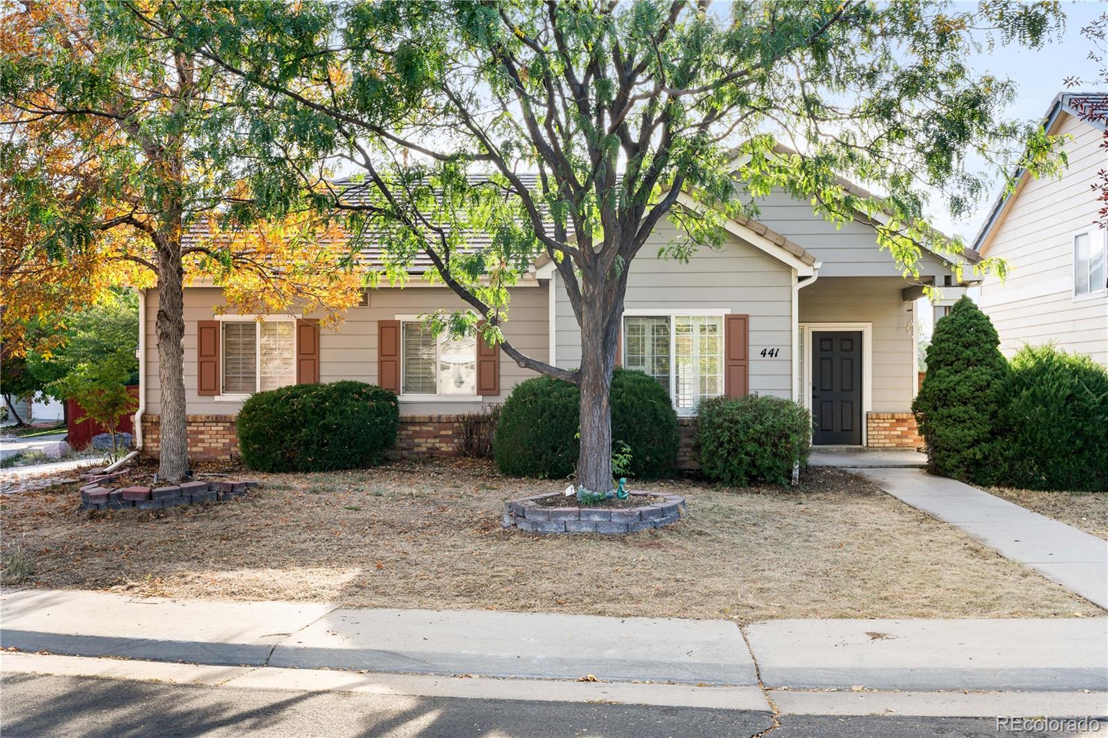 a view of a house with a tree in front