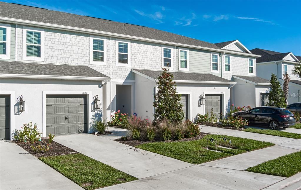 a front view of a house with a yard and garage