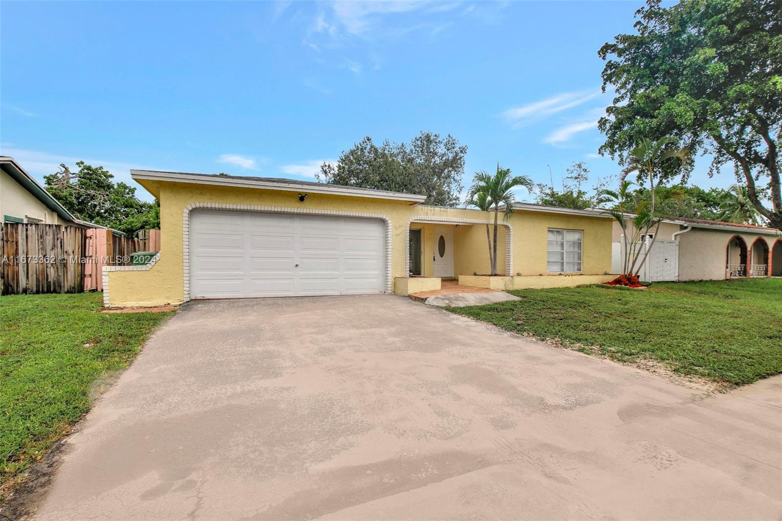 a front view of house with yard and garage