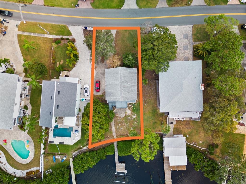 aerial view of a house with large trees and plants