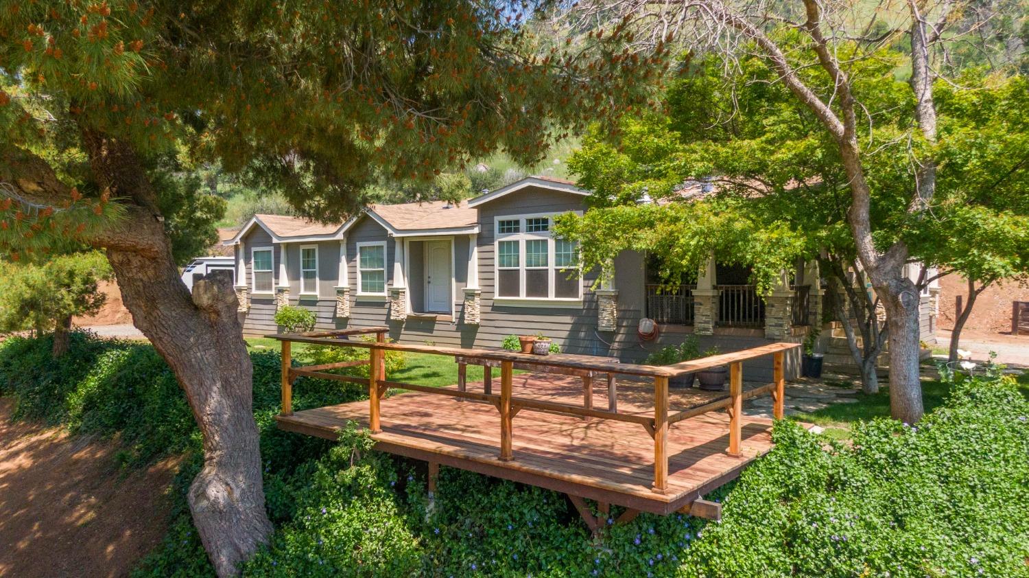 a view of a house with backyard porch and sitting area