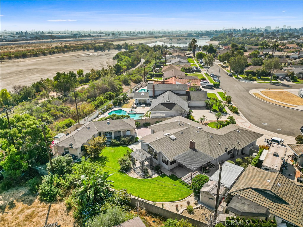 an aerial view of residential houses with outdoor space and swimming pool