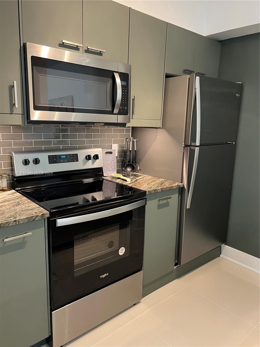 a kitchen with a stove microwave and refrigerator