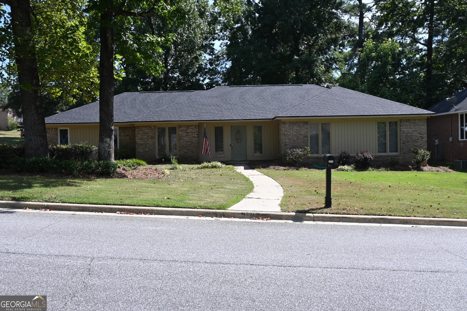 a front view of house with yard and green space