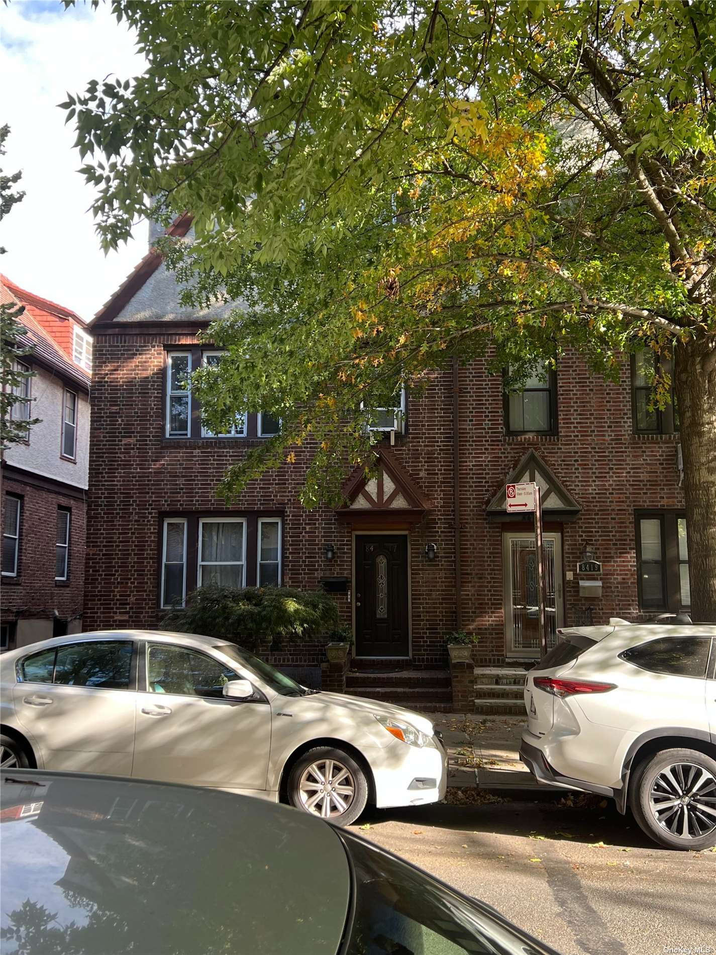 a front view of a house with parking space