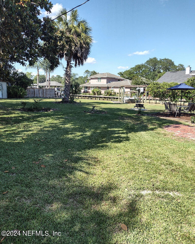 a view of swimming pool with outdoor seating and garden