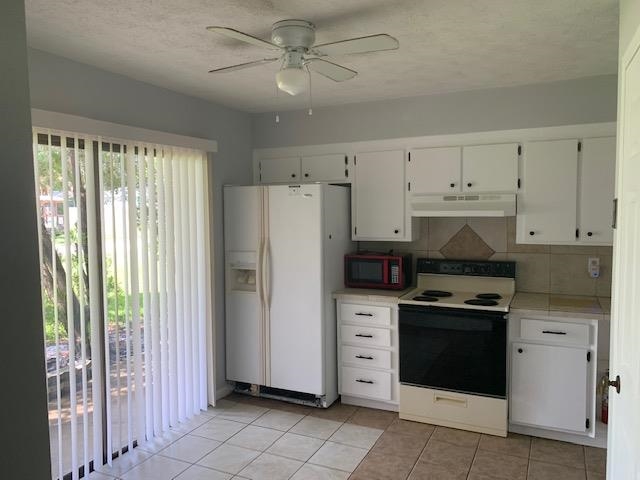 a kitchen with stainless steel appliances a stove a refrigerator and a window