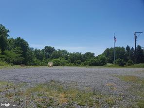 a view of a field with trees in background