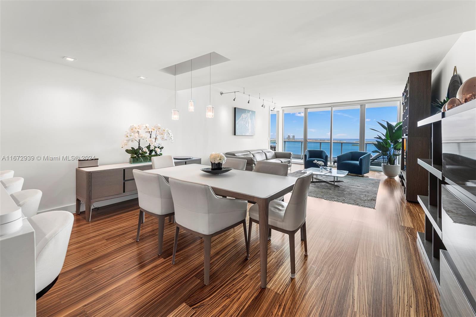 a view of a dining room with furniture and a kitchen