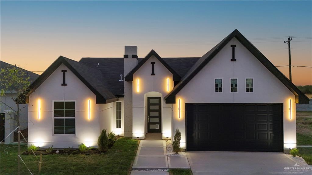 View of front of property featuring a garage