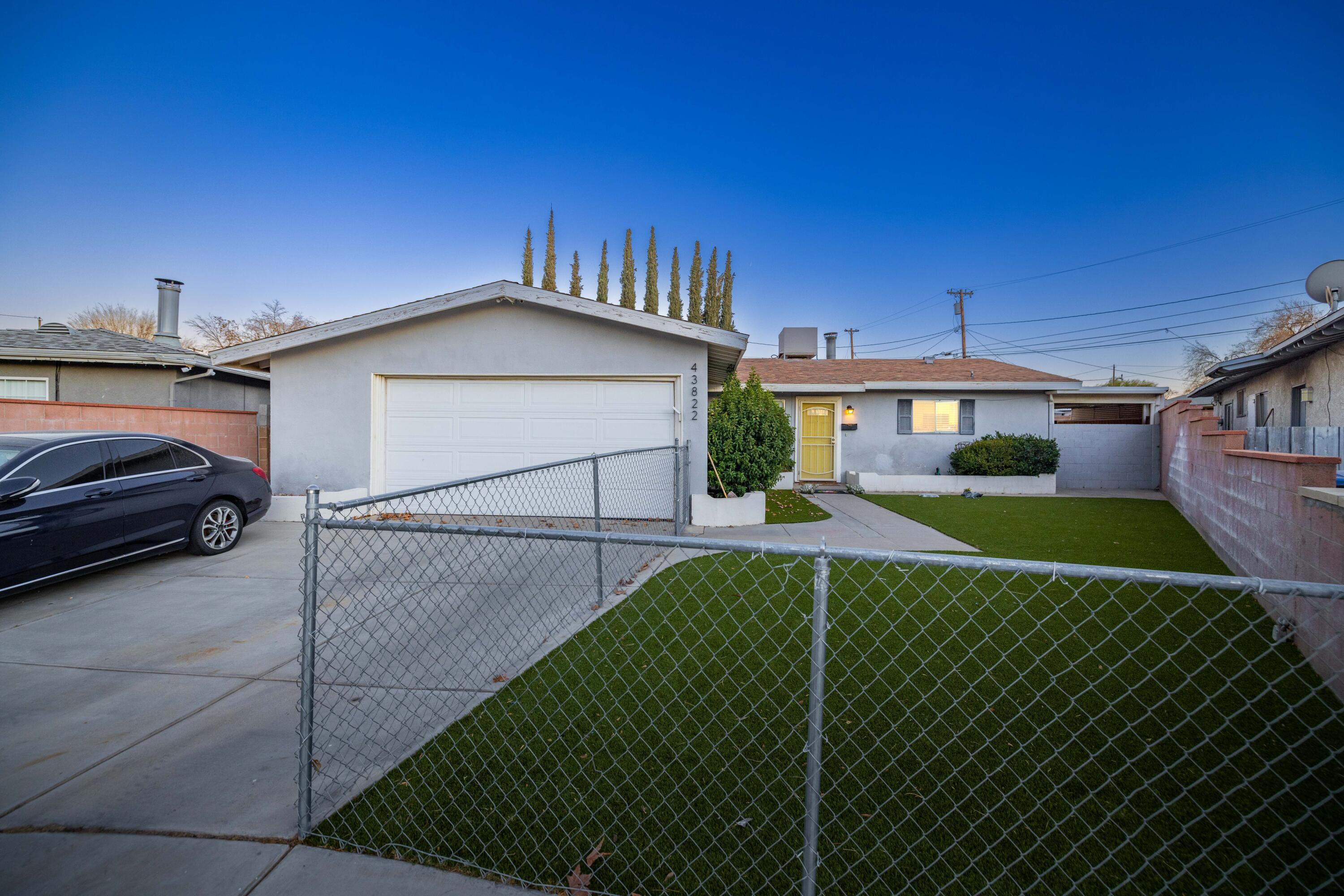 a view of a house with a backyard