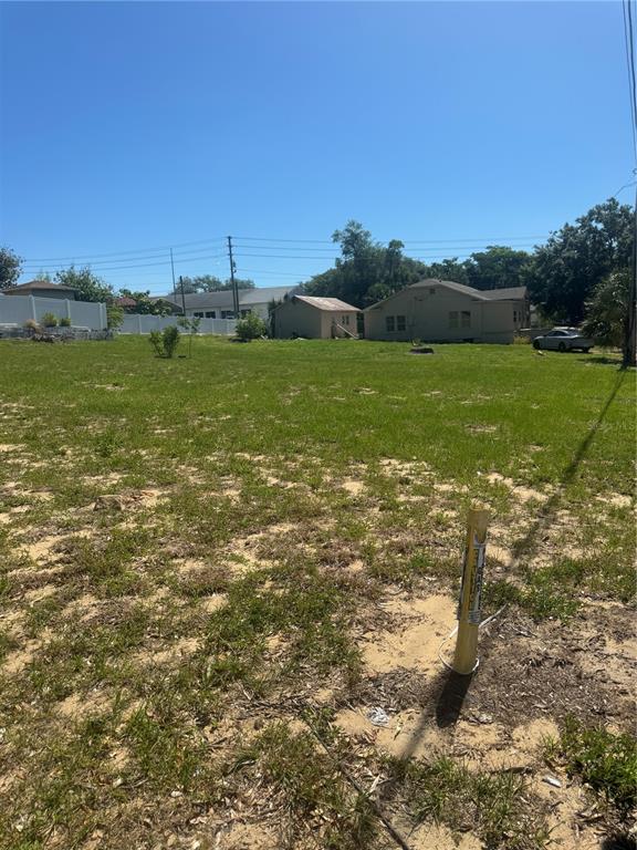 a view of a field with an ocean view