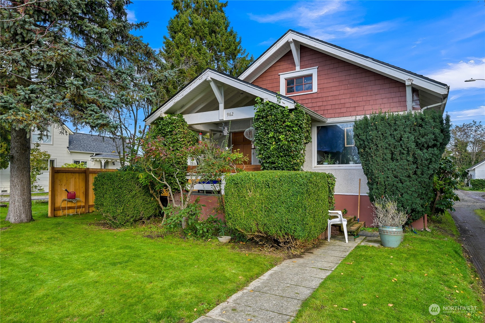 a front view of a house with a yard and trees