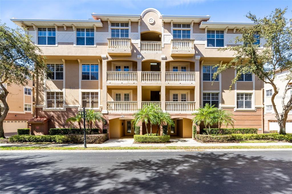 a front view of a residential apartment building with a yard