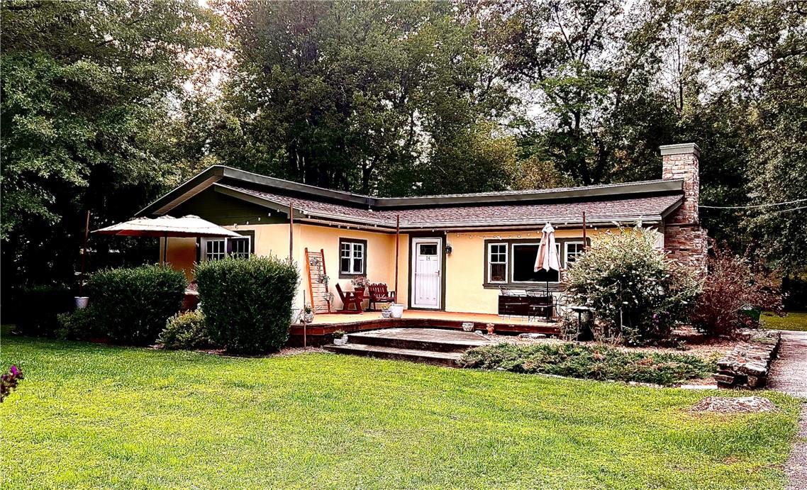 a front view of house with yard and green space