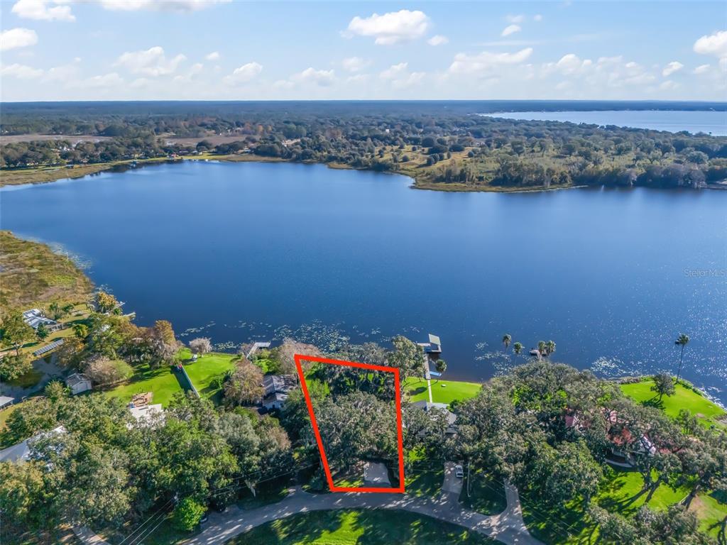 an aerial view of a house with a lake view