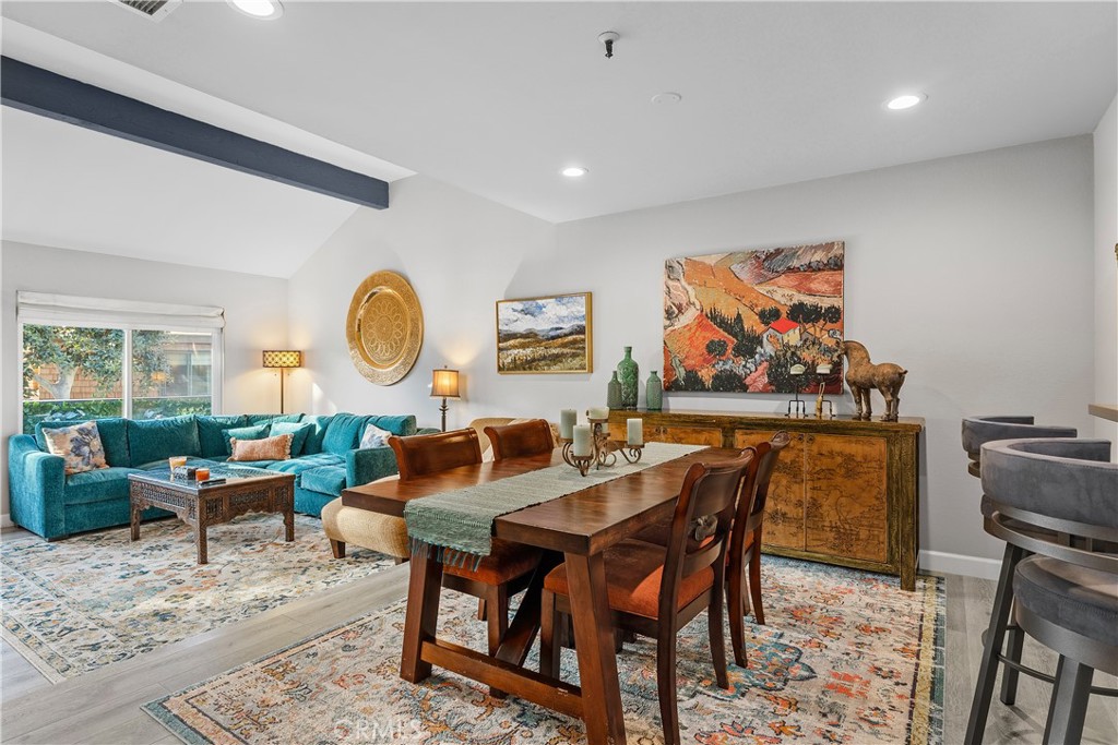 a dining room with furniture a rug and a window