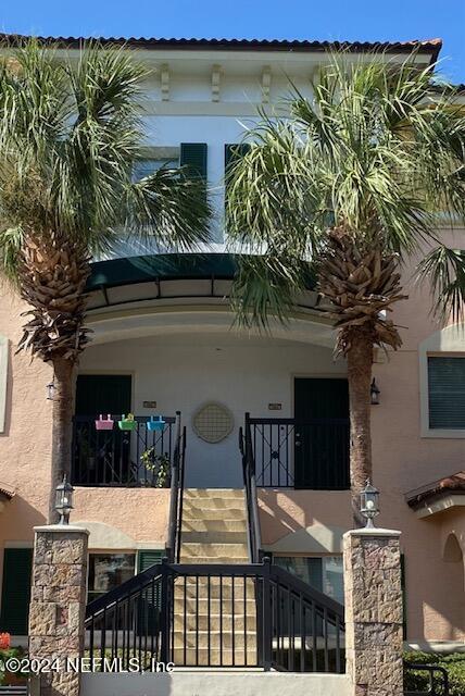 a view of front door and potted plants