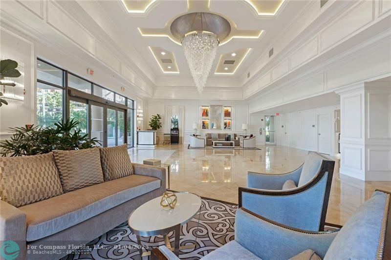 a living room with furniture chandelier and a chandelier