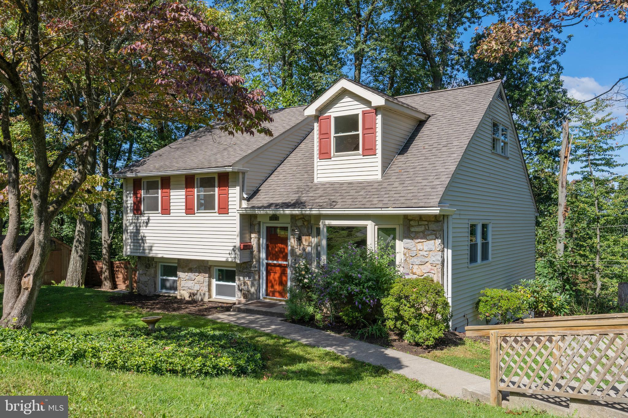 a front view of a house with a garden and deck