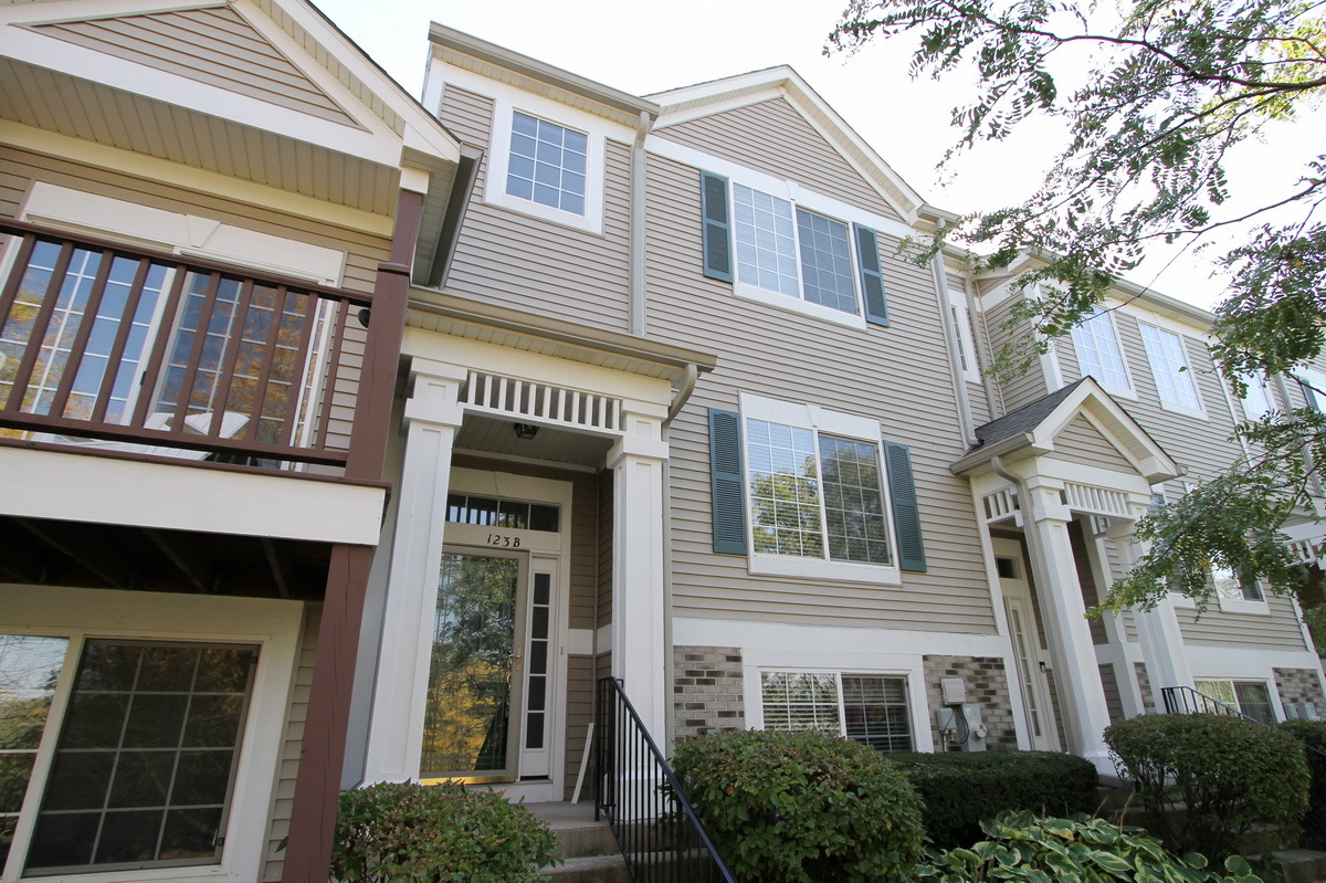 a front view of a house with large windows