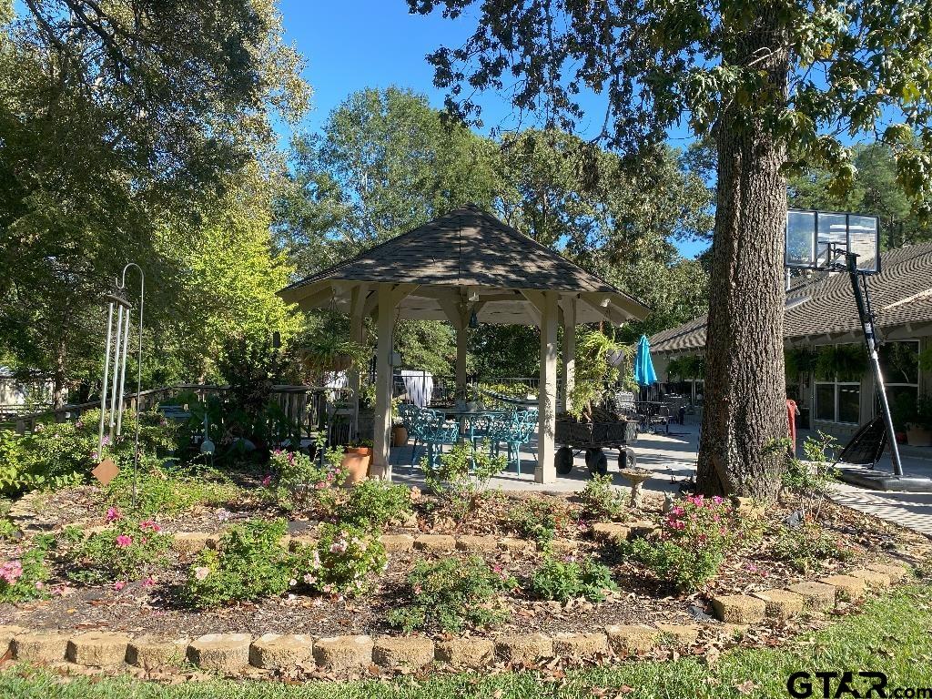 a view of a bench in a backyard of a house