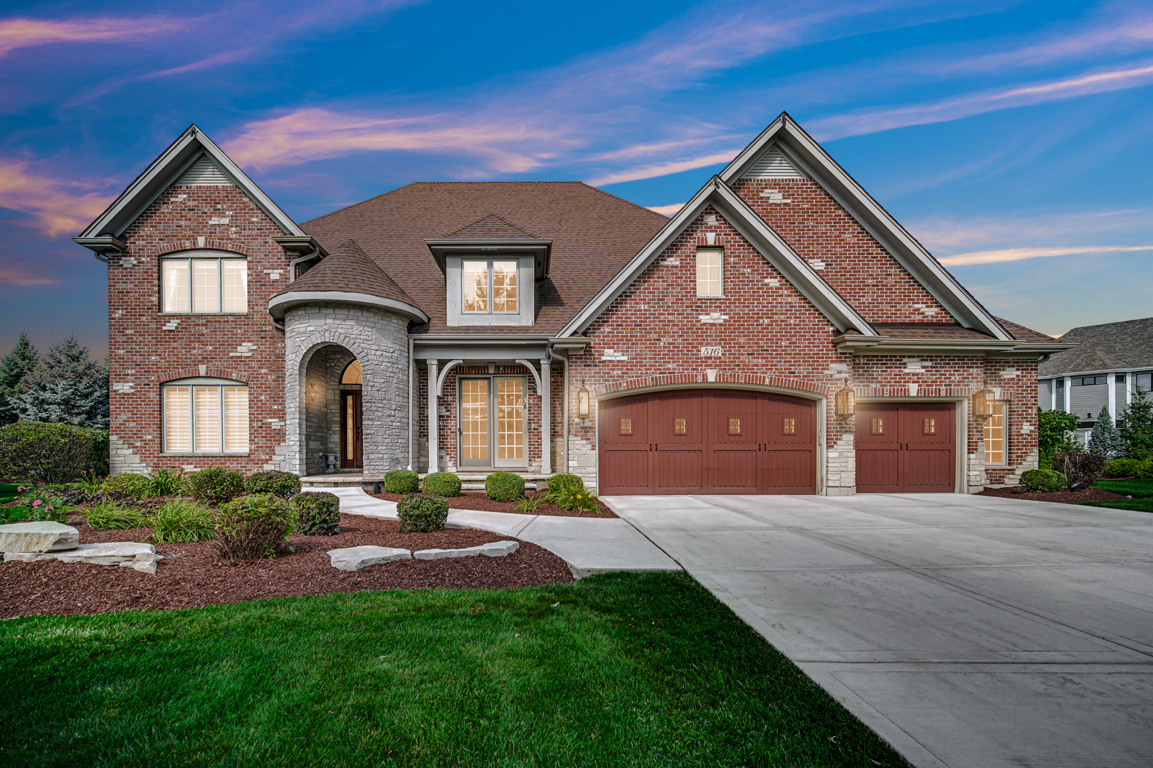 a front view of a house with a yard and garage