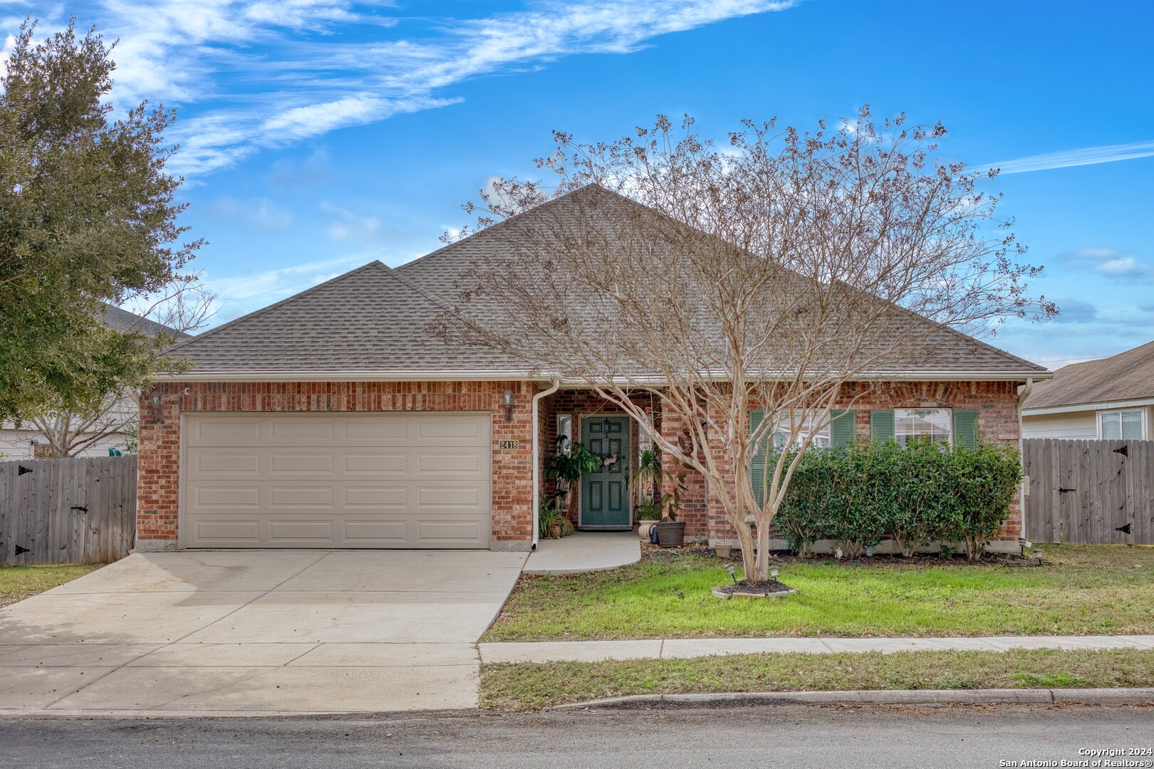 a front view of a house with a yard garage and outdoor seating