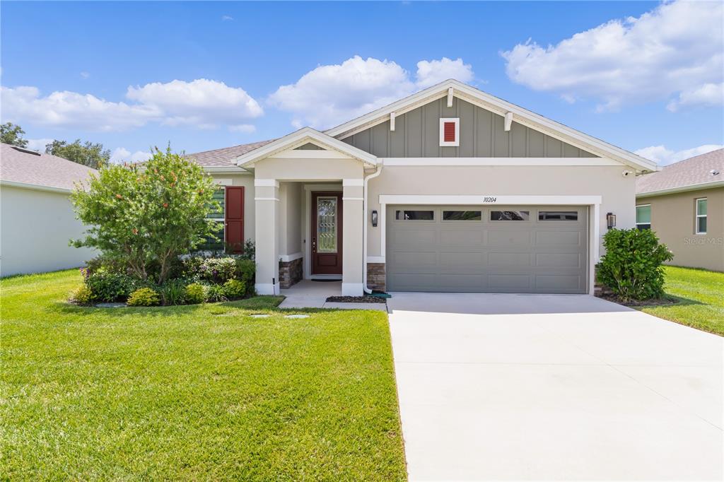 a front view of a house with a yard and garage