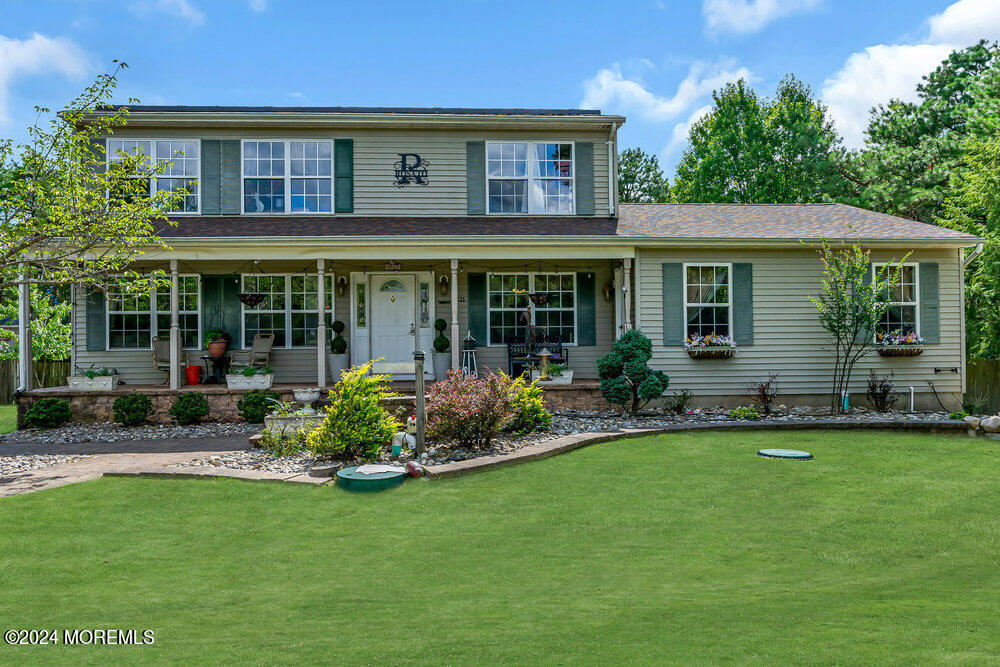 a front view of a house with a garden and porch